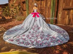 Be selfie ready in this three-piece floral charro off the shoulder ball gown with A-line skirt by Ragazza Fashion M50-150. This beautiful long off the shoulder dress features a sweetheart corset bodice, open lace-up back, and a floor length A-line skirt with a sweep train. The bolero jacket is included – giving you a versatile second look throughout your party! The cowboy hat shown in the catalog pictures is not included. 3-Piece Charro Quinceanera Dress by Ragazza M50-150 Designer: Morena y Esencial Pioneer Collection by Ragazza Fashion 2024 Style Number: M50-150 Colors: Silver/Fuchsia Pink Sizes: 3, 5, 7, 9, 11, 13, 15 Since this is a three-piece dress, the top skirt and bodice are removable. We love this because it gives you multiple looks throughout your party. The cowboy hat shown in 1500 Dresses, Charro Quinceanera Dresses, Xv Dresses, Military Ball Dresses, Dresses Quinceanera, Gowns For Girls, Ball Gown Skirt, Quinceanera Dresses, Formal Evening Dresses