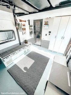 the interior of an rv with white walls and black flooring is shown in this image