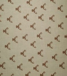 the fabric has deer heads on it in brown and beige colors, as well as white background