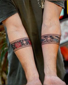 two people with matching tattoos on their arms