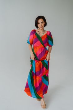 A stunning color blocked dress! The fit and flow is absolutely perfect. Short sleeve puff sleeve Ruffle tiered maxi dress Side zipper 100% polyester Model is 5'0" and wearing a size small. The length of a size small measures 54". X-small: 0-2 Small: 2-4 Medium: 6-8 Large: 10-12 Serena Dress, Tiered Maxi Dress, Colorblock Dress, Side Zipper, Colorful Fashion, Puff Sleeve, Color Block, Dresses For Sale, That Look