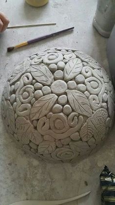 a large rock sitting on top of a table next to a pair of scissors and pencils