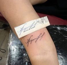 a woman's arm with a tattoo on it that has the word strength written in cursive writing