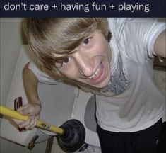 a young man holding a baseball bat in front of a toilet with the caption don't care having fun playing