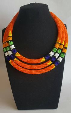 This multi strand necklace can be worn in almost all occasions. Perfect for weddings, parties, African themed events etc. The necklace makes a perfect gift. 100% handcrafted using fine beads. **Buy multiple items and pay shipping for 1 item only.The rest ships free. More neckleces here; https://www.etsy.com/shop/TribalTess?ref=seller-platform-mcnav&section_id=21306083 Back to my shop; https://www.etsy.com/shop/TribalTess?ref=seller-platform-mcnav White Beaded Choker For Festivals, Traditional Double Strand Beads For Gift, Double Strand Polished Bead Necklaces, Double Strand Polished Beads Necklace, Traditional Orange Multi-strand Jewelry, White Beaded Necklaces For Festivals, Orange Double Strand Beaded Necklace As Gift, Orange Double Strand Beaded Necklace For Gift, Handmade Multi-strand Beaded Necklaces For Festivals