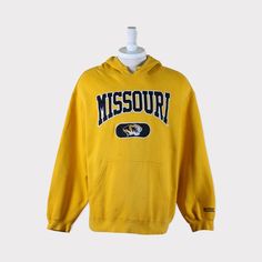 Embroidered Vintage 90s Missouri Tigers (University of Missouri) Football/Baseball/Basketball/Hockey NCAA Hoodie 💯 SATISFACTION AND AUTHENTICITY ⭐ MEASUREMENTS (when laid flat) Size on Tag: XL Length: 72cm or 28.5 inches Armpit to armpit: 60cm or 23.5 inches ⭐ CONDITION 9/10 (Very good) Details: No holes Material: Cotton Color: Yellow Brand: 🔷 Please give us your phone no. together with address after you purchased. 🔷Please keep in mind that our items are vintage so they may show some signs of Missouri University, School Merch, 90s Culture, Tiger Hoodie, Football Sweater, Culture Fashion, Missouri Tigers, University Of Missouri, Tiger T Shirt