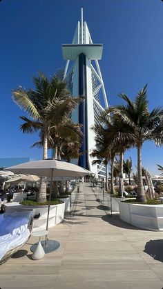 a tall tower with palm trees next to it