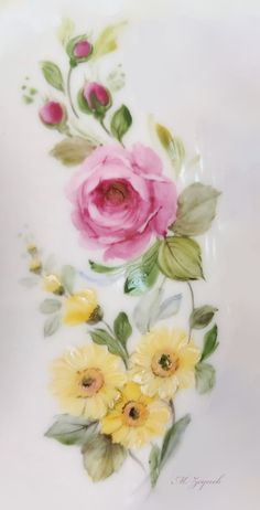 two pink and yellow flowers on a white plate