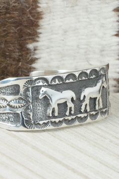 This sterling silver bracelet was made by Navajo silversmith Emerson Kinsel. The inside is signed K and stamped sterling.Size: 5 1/2" (will fit up to a 6 3/4" wrist)Gap: 1 1/4"Length: 7/8"Free shipping on all orders! We ship with USPS and always include tracking. All orders ship within a day of payment.Returns are accepted up to 30 days after you receive your order. Just send us a message. Our shop offers cash back or store credit. The item must be returned in new condition. Nickel-free Southwestern Sterling Silver Bracelet, Handmade Western Silver Cuff Bracelet, Artisan Silver Bracelet With Stamped Details, Adjustable Southwestern Sterling Silver Bracelet, Handmade Western Sterling Silver Cuff Bracelet, Stamped Sterling Silver Bangle Bracelet, Adjustable Stamped Sterling Silver Bracelet, Stamped Sterling Silver Bangle, Artisan Sterling Silver Bracelet Nickel-free