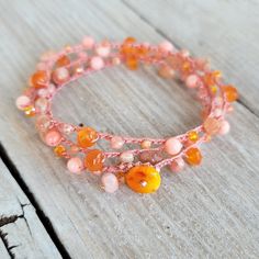 "Pink and Orange gemmy boho beaded crochet bracelet wrap...made in Hawaii and ready to ship! Grab your 15% off code now by signing up to my VIP group here: http://eepurl.com/c5riDL ↓ more details below on this bracelet * carnelian, pink coral, sunstone, rhodocrisite, crystals, silverite * nylon bead cord * orange coral button clasp * 14k gold fill wire beaded charm A Hawaii sunrise mix of randomly placed pink and orange gems and crystals with:  carnelian, pink coral, sunstone, pink rhodocrisite Orange Gem, Pink Dye, Crochet Beaded Bracelets, Boho Wrap Bracelet, Beaded Crochet, Unique Jewelry Gifts, Vip Group, Orange Coral, Crochet Bracelet