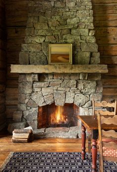 a stone fireplace in the middle of a room