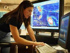 a woman looking at a computer screen with the caption's logo on it