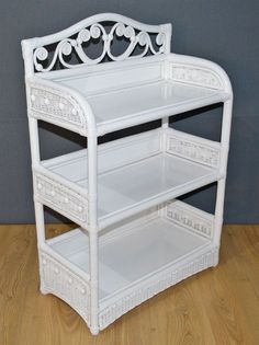 a white shelf sitting on top of a wooden floor