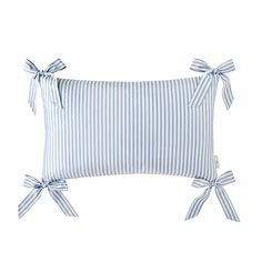 a blue and white striped pillow with bows on the front, tied in a bow