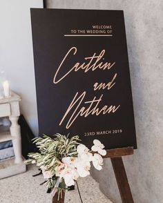 a sign that says cotton and maton on it next to a vase with flowers