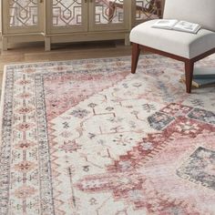 a large area rug with an ornate design on the front and side, in a living room