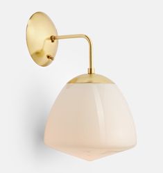 a white and gold wall light on a gray background with the arm extended to it's left side