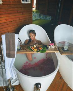 a woman sitting in a bathtub filled with water and food on top of it