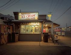 an ice cream shop is lit up at night