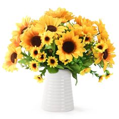 a white vase filled with lots of yellow sunflowers