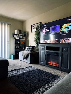 a living room filled with furniture and a flat screen tv on top of a wall