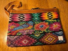 This handcrafted 100% cotton and genuine leather purse was made in the highlands of Guatemala.  The fabric is vintage recycled ladies Huipil blouses and genuine leather.  Each purse has a double pull zipper and is completely lined inside. Vintage Multicolor Bags With Zipper Pouch, Brown Handwoven Pouch For Everyday Use, Brown Handwoven Pouch, Vintage Multicolor Clutch For Daily Use, Traditional Brown Pouch For Everyday Use, Multicolor Woven Pouch For Everyday Use, Traditional Multicolor Wallet For Everyday Use, Traditional Clutch With Removable Pouch For Everyday, Vintage Multicolor Travel Wallets