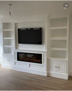 an entertainment center with built in bookshelves and a flat screen tv mounted on the wall