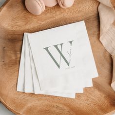 three napkins with the letter w on them are sitting on a wooden tray next to an egg