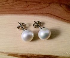 White color freshwater pearl studs .  10 mm , set on a sterling silver . Perfect gift for yourself , your best friend or  bridesmaids. Comes wrapped as  a gift  . colors may vary. The box in a picture is only for display. Any special request -  just write it to me in the "message to the seller" box of the order form. **LIMITED SUPPLY** All of our jewelry comes wrapped and ready for gift giving! To see more, please visit my shop at http://www.etsy.com/ca/shop/BadassjewelryToronto Hypoallergenic Pearl Earrings Gift, Gift White Round Beads Pearl Earrings, Gift White Pearl Earrings, Gift White Round Pearl Earrings, White Round Beads Pearl Earrings Gift, Gift Pearl Earrings, Pearl Earrings As A Gift, Round Pearl Earrings As Gift, Gift Pearl Earrings With Round Beads