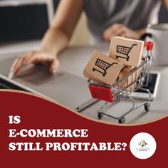 a shopping cart with cardboard boxes on it sitting in front of a laptop that says is e - commerce still portable?