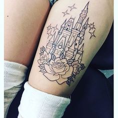 a woman with a tattoo on her arm that has a castle and roses in it