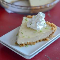 a piece of pie sitting on top of a white plate next to a glass bowl