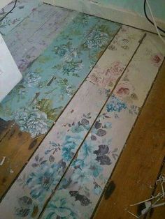 the floor is covered in old wallpaper and has been painted with floral designs on it