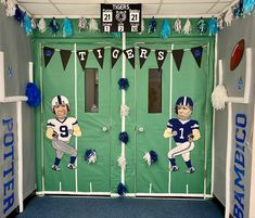 two football players are painted on the front door of a locker with pom poms