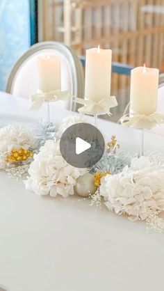 a white table topped with candles and flowers