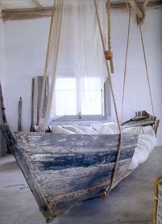 an old boat is hanging from a rope