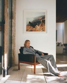 a woman sitting in a chair with her legs crossed