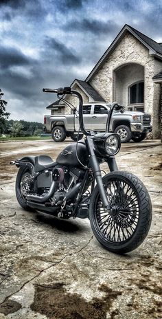 a black motorcycle parked in front of a house