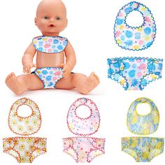 a baby doll sitting on the ground with several bibs around it's body