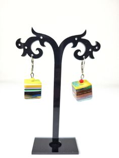 These earrings are part of the Pop Art line and are called Popinho Medio. The Pop Art line was created by Sobral to represent the passage of Modernity into Post Modernity in the Western culture. These earrings are the Day version and feature a multicolor striped dangling cube. They measure 1 3/8" in total length and the diameter of the cube 5/8". I also have necklaces, bracelets and rings available in this pattern. The first United Nations Conference to address environmental degradation was held in Stockholm in 1972. Already at that time the designer Carlos Sobral was working with resin and creating new techniques and alternative products to reuse all the raw material he consumed in the production of his collections. All Sobral production strictly follows the current environmental standard Adjustable Rainbow Earrings As Gift, Artisan Earrings With Artistic Design For Gift, Artisan Earrings With Artistic Design As A Gift, Handmade Multicolor Earrings For Gift, Handmade Multicolor Earrings As Gift, Multicolor Single Earring Jewelry Gift, Multicolor Single Earring As Gift, Rainbow Single Earring As Gift, Unique Rainbow Earrings