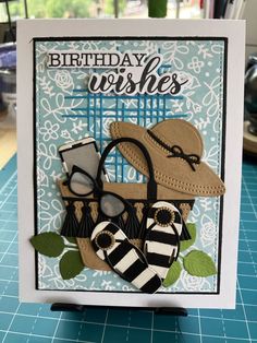 a handmade birthday card with shoes and hats on the front, sitting on top of a table