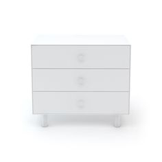 a white dresser with three drawers and two knobs on the front, against a white background