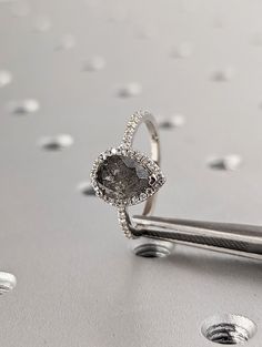 a diamond ring sitting on top of a piece of metal