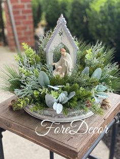 a table topped with a mirror and greenery