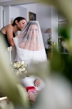 the bride is getting ready to walk down the aisle with her veil over her head