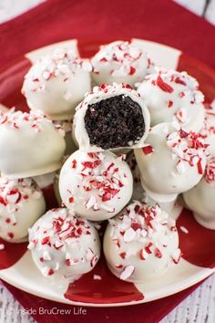 a plate full of white chocolate truffles with red and white sprinkles