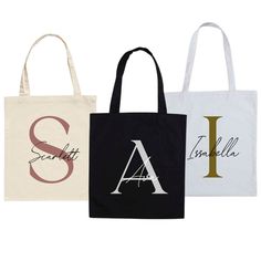 three tote bags with the letters i, l, and person on them in different colors