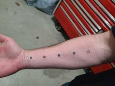 a man's arm with small dots on it