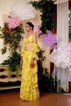 Like walking in a field of flowers where all the flowers bloom under the sun. The energy this co-ord set radiates is incomparable. The joy and comfort of the sun are presented in this set with utter glamour. The flared pants and a top in the shape of a butterfly are paired with a ruffle-sleeved dupatta which ties in the glamour and youth of the dress. The sleeveless blouse comes with drop-down ruffled sleeves along with a criss-cross pattern at the back. Hook at the back of the blouse. Sharara p Summer Party Palazzo Set With Floral Print, Summer Floral Print Palazzo Set For Parties, Bohemian Floral Embroidered Palazzo Set For Summer, Bohemian Floral Embroidery Palazzo Set For Summer, Summer Party Palazzo Set With Floral Embroidery, Yellow Lehenga For Spring, Spring Yellow Lehenga, Fitted Floral Print Palazzo Set For Spring, Fitted Yellow Lehenga With Floral Print