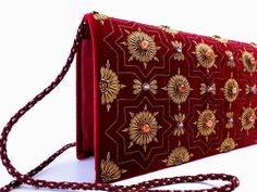 "Burgundy velvet clutch bag, zardozi evening bag, embroidered with copper medallions and embellished with genuine semi precious stones, to give an opulent, multidimensional dazzling effect. This is a gorgeous wardrobe investment piece! A classic design that will never go out of style! A modern heirloom to be cherished! Add instant glamour and elegance to any ensemble! Perfect for any evening occasion, be it wedding, gala, cocktail party. The word Zardozi means \"gold thread\". It is an elaborate Gold Evening Bag For Diwali, Festive Formal Evening Bag With Gold Embroidery, Formal Festive Evening Bag With Gold Embroidery, Evening Potli Bag With Gold Embroidery For Festivals, Gold Evening Bag With Mirror Work For Festivals, Velvet Clutch Evening Bag For Wedding, Elegant Evening Bag With Handwork For Diwali, Luxury Gold Embroidered Potli Bag For Festive Occasion, Elegant Red Potli Bag For Evening